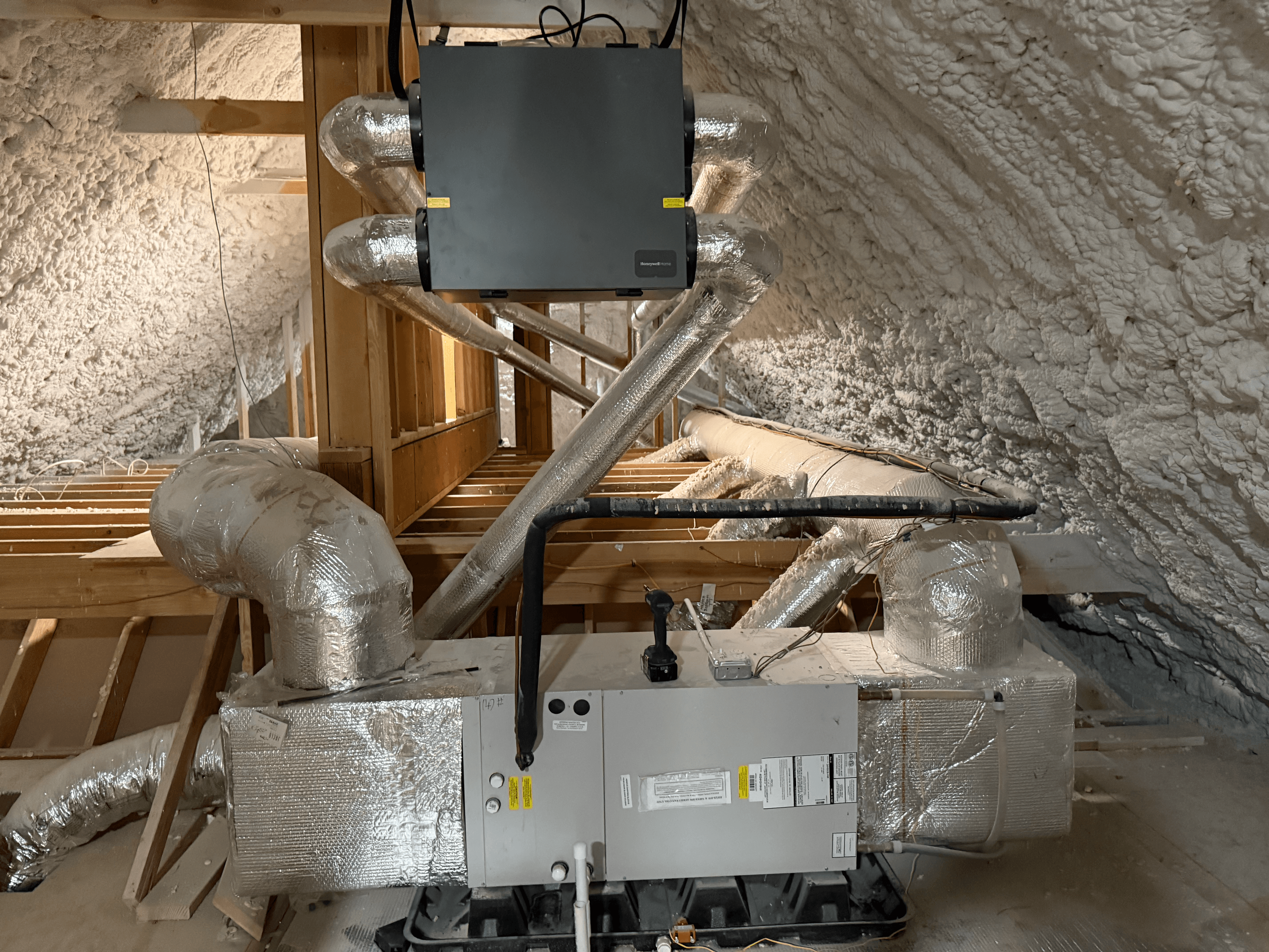Air handler and ERV unit in attic with spray foam insulation